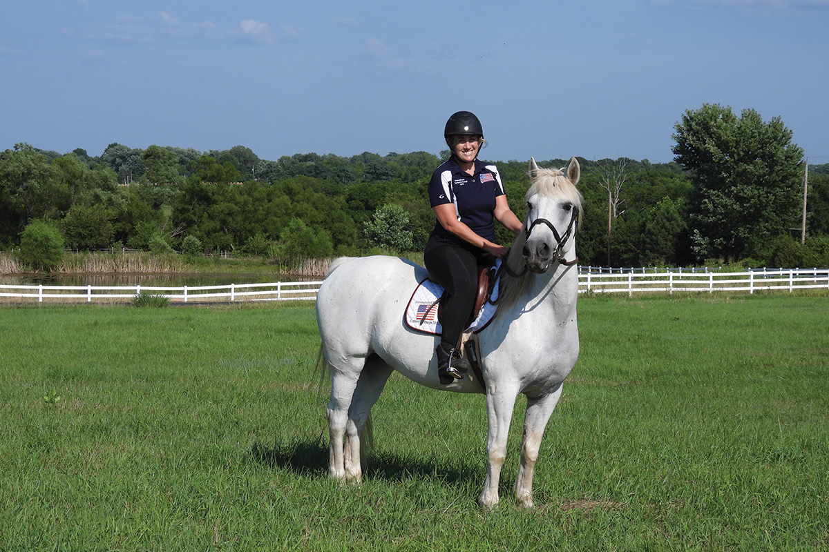 Hard-to-adopt horse Ozzie found a home with trainer Cathie Chiccine, who is riding him here