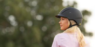 A cowgirl wearing a helmet.