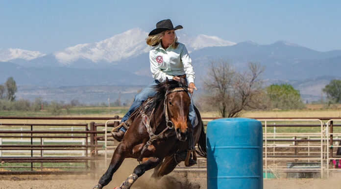 Barrel racing with mountains in the background
