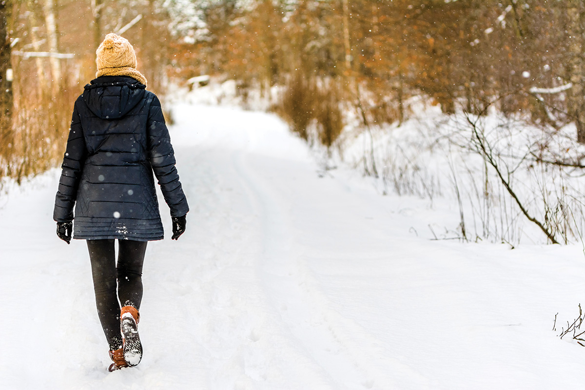 A woman walking in the snow.
