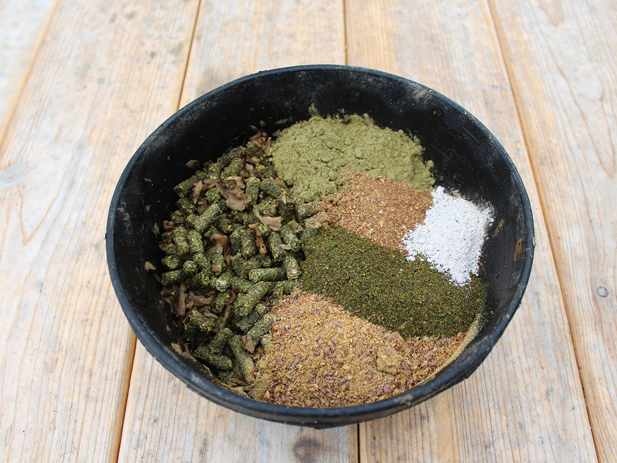 A tub of horse feed with calming supplements and ingredients