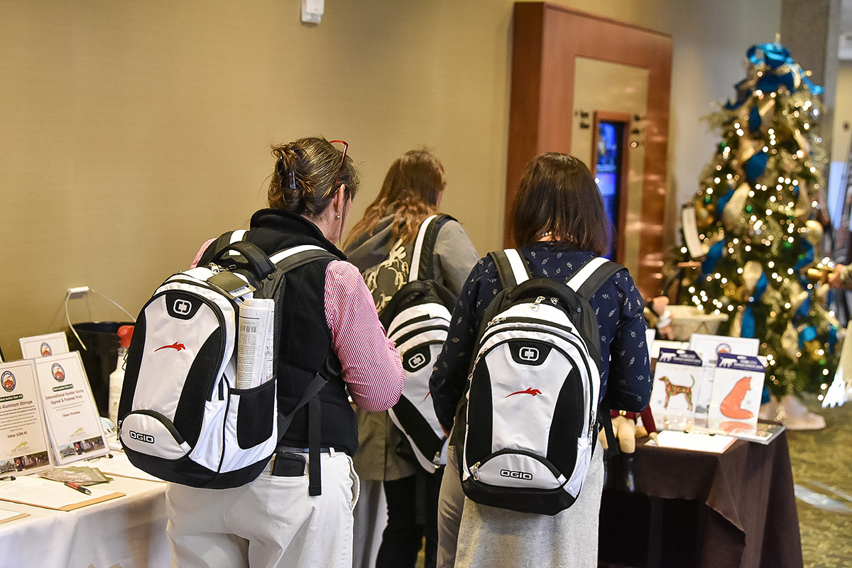 Equestrians wearing free backpacks at the USHJA convention
