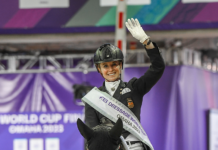 Dancing Horses Take Center Stage at Omaha World Cup Finals TSF Dalera BB wearing her World Cup Finals Freestyle Champion cooler and rider Jessica von Bredow-Werndl in her Champion sash