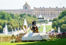 Laura Collett and London 52 on the 2024 Paris Olympics cross-country course with the Palace of Versailles setting the scene