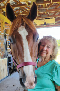 An older woman with an older horse
