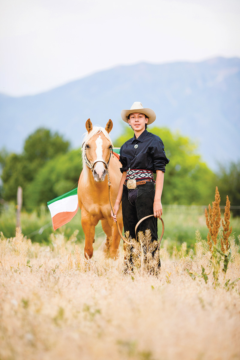 A young man with a palomino horse