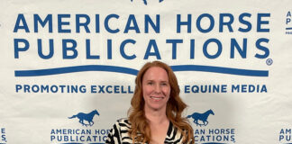 Horse Illustrated editor Holly Caccamise holding up one of the publication's awards
