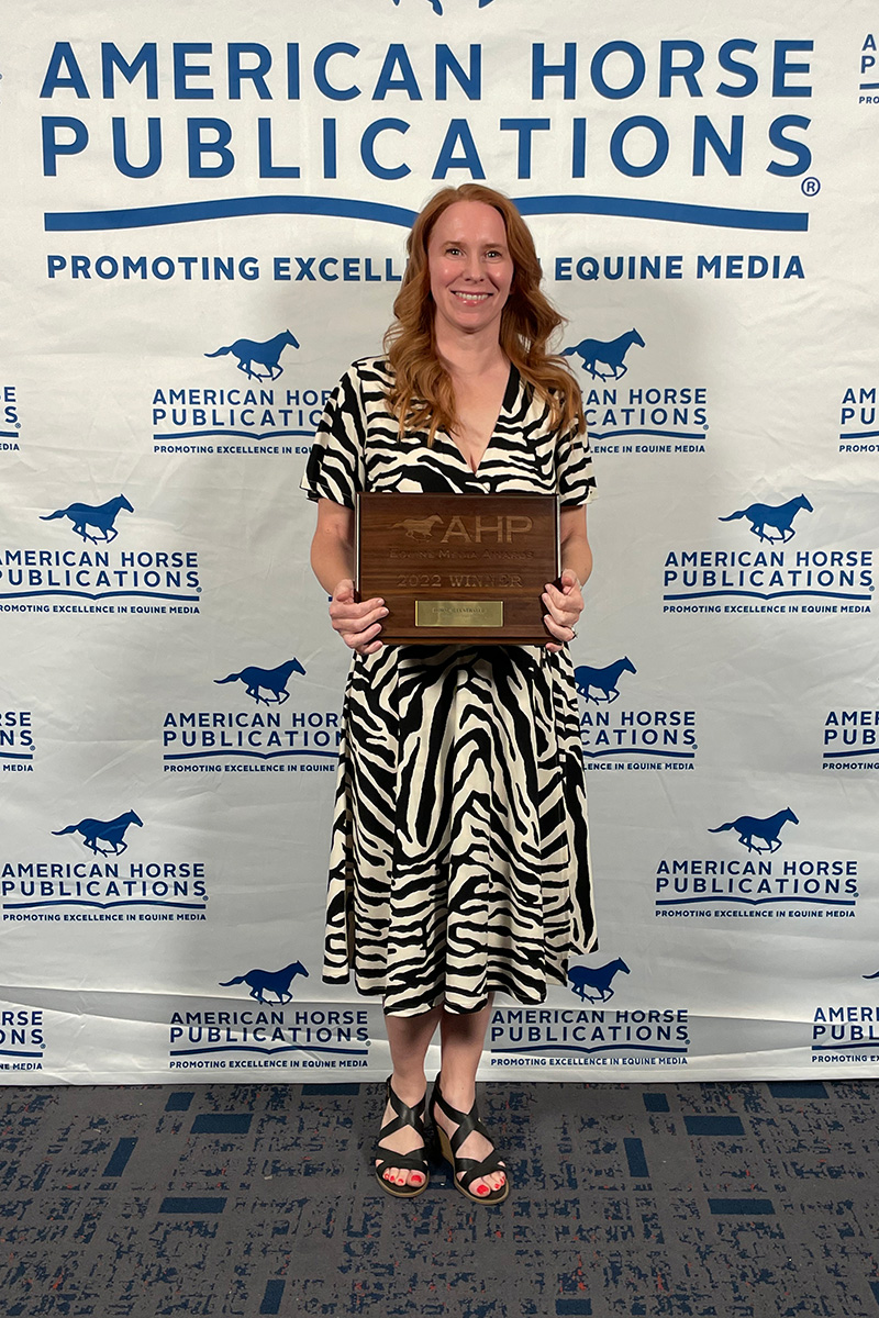 Horse Illustrated editor Holly Caccamise holding up one of the publication's awards