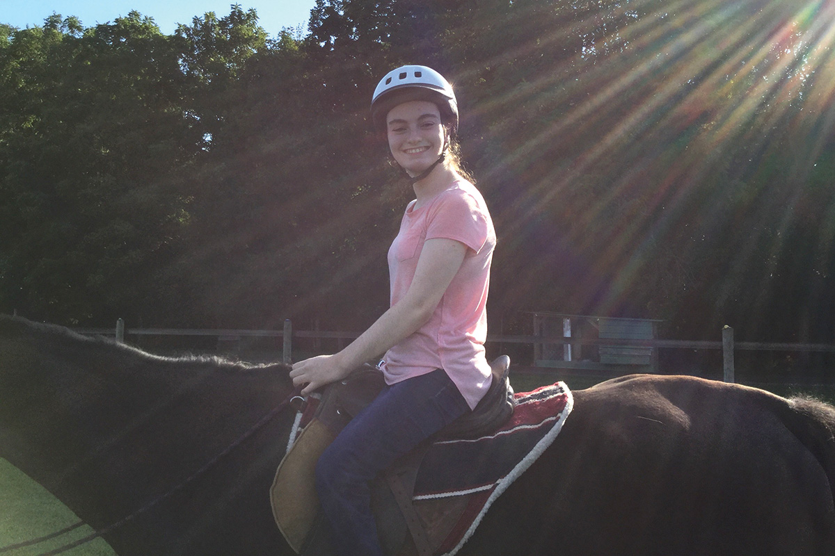 Jewell Cox riding at her therapeutic riding center