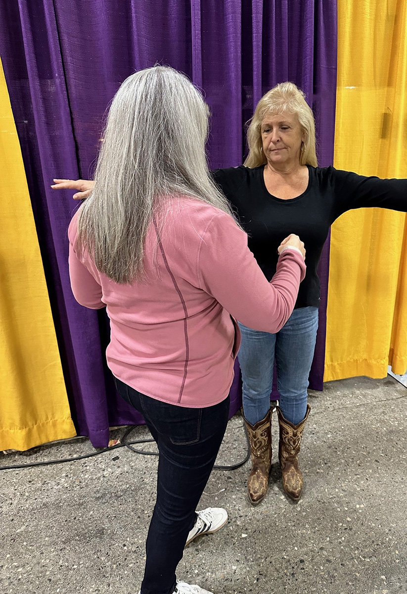 Chick obtains three measurements for a proper safety vest fit: bust, back length, and over the shoulder.