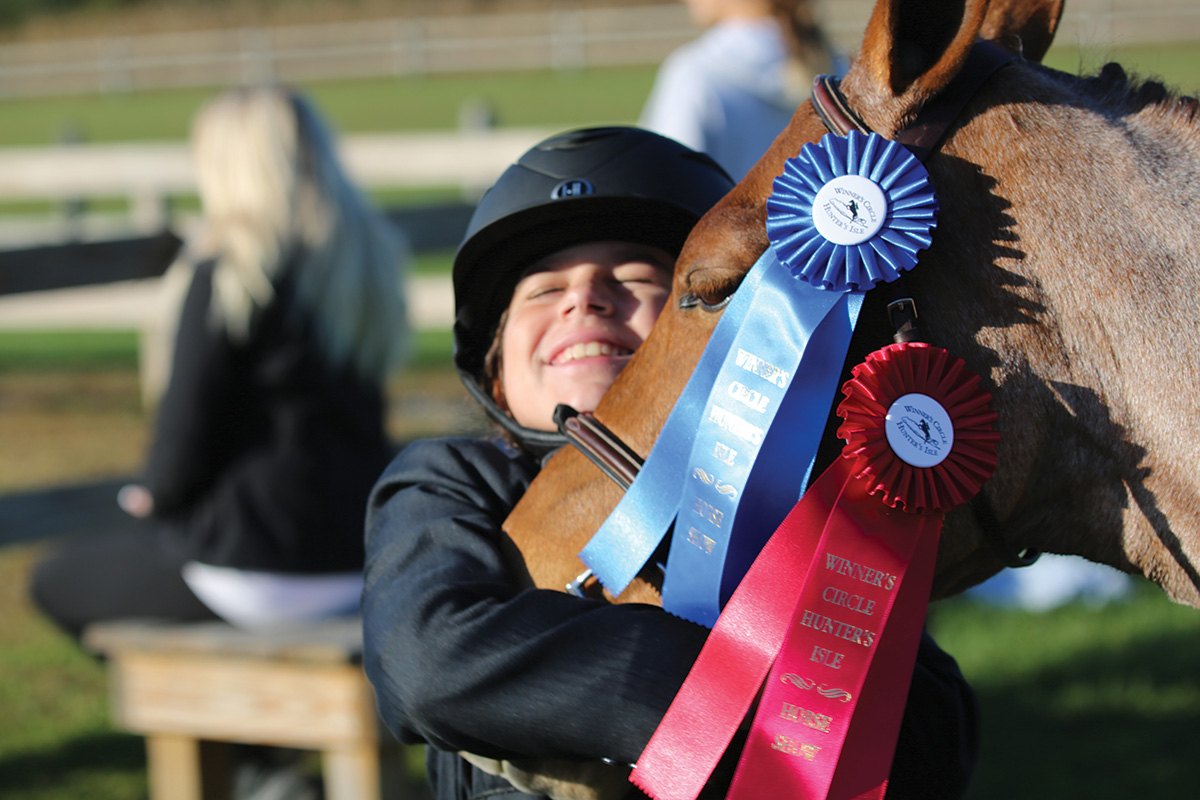 A young rider celebrates the success of her New Year riding goals.