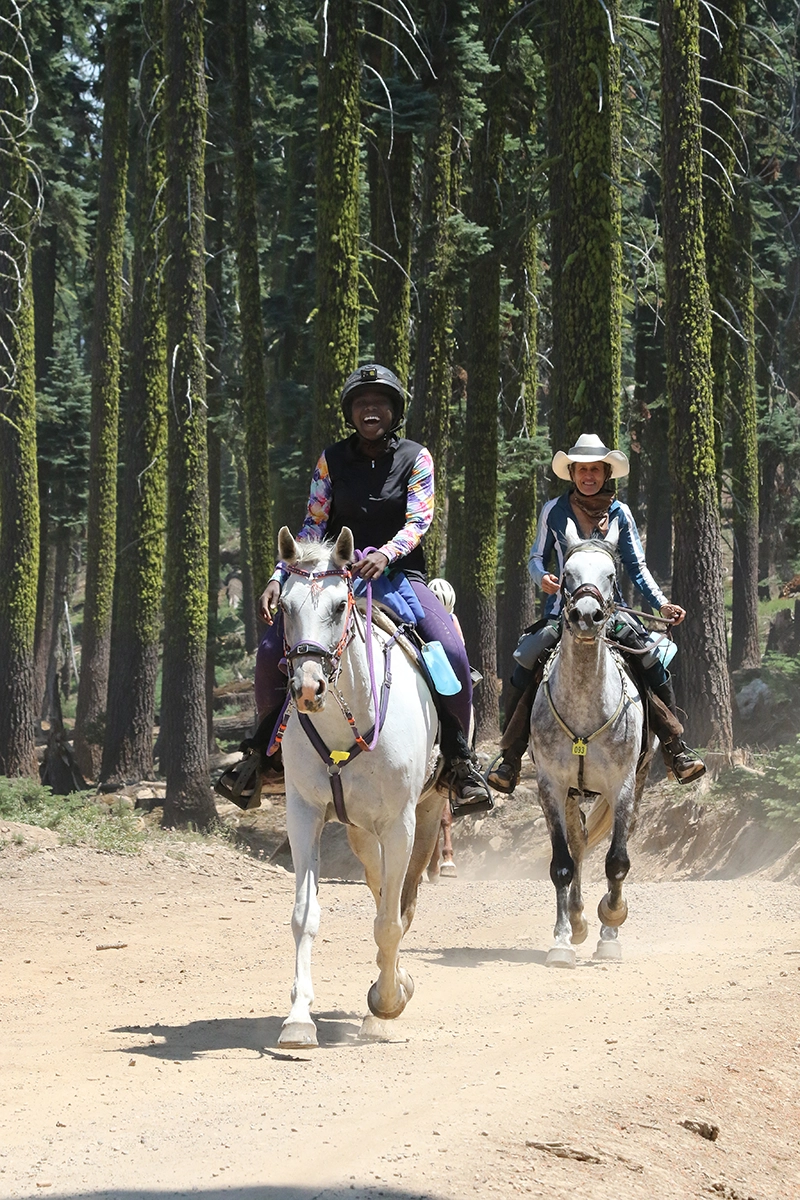 Erna Valdivia and Susannah Jones riding on a trail.