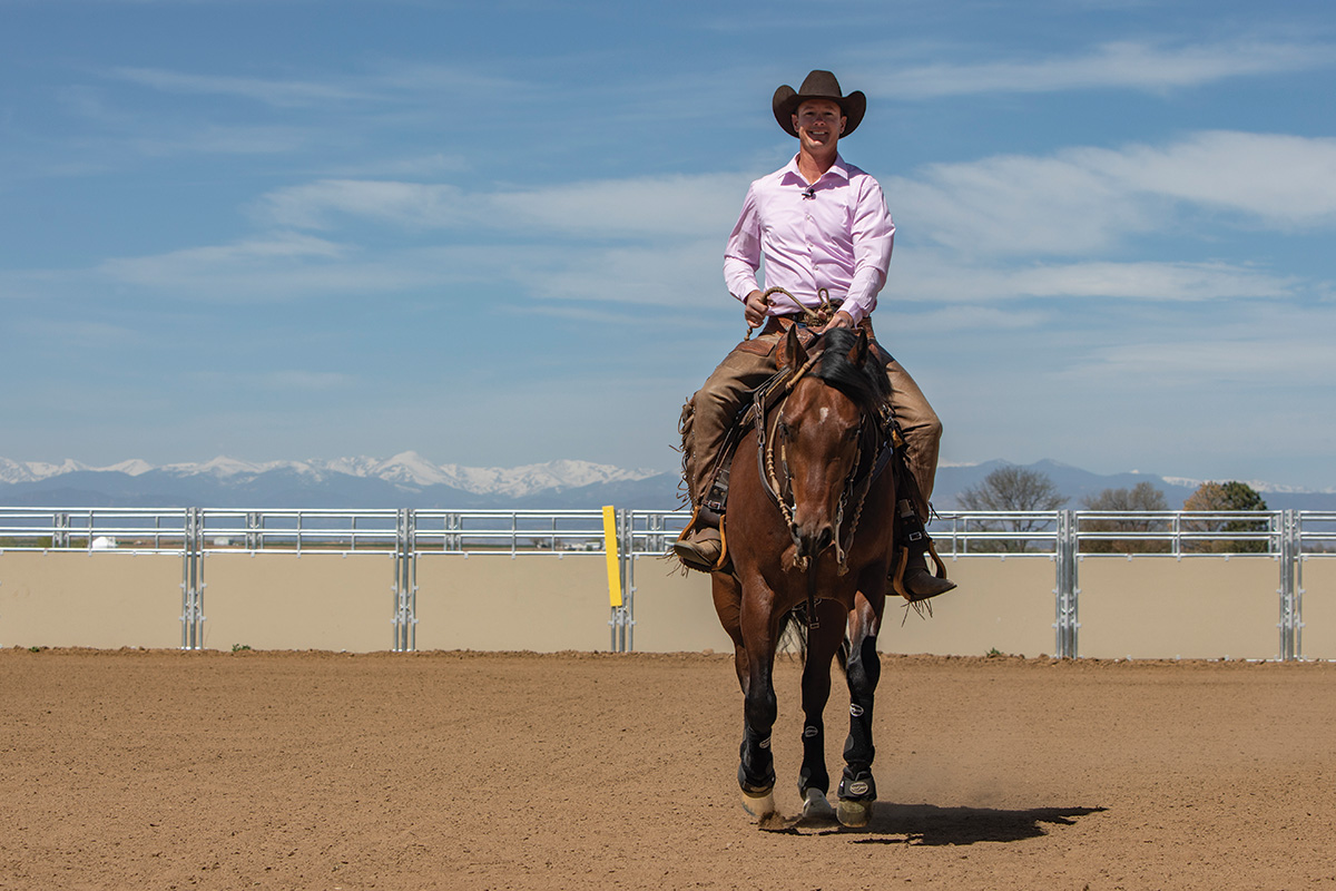 A head-on shot of Cody Crow riding a bay in an outdoor arena