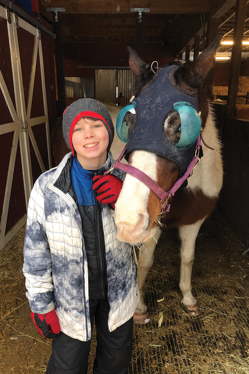 A young boy with Trixie, a horse with an ongoing eye problem who benefitted from the Vet Direct Safety Net program