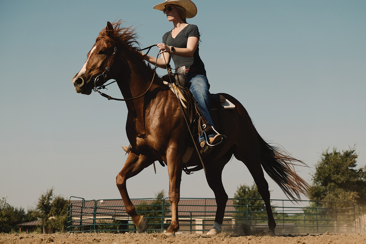 A barrel racer loping a sorrel