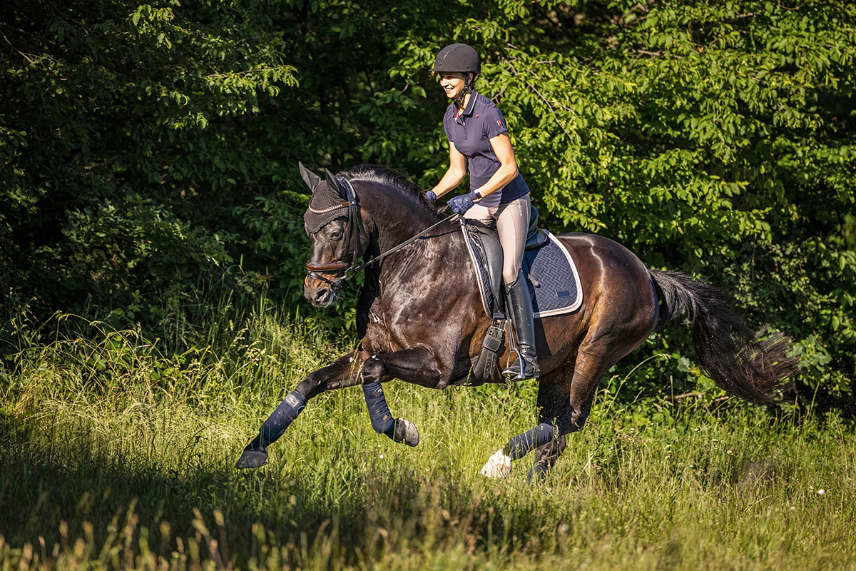An equestrian overcoming riding anxiety with a smile while galloping