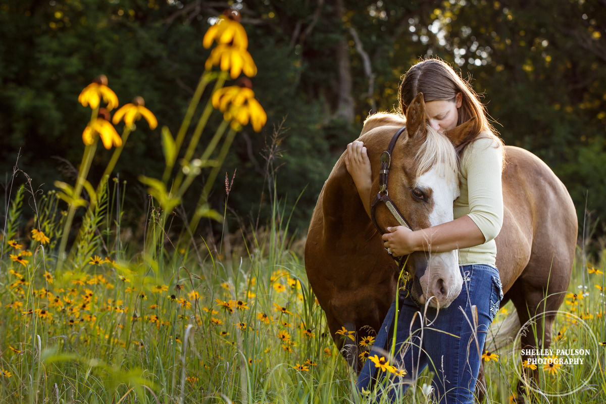 Woman hugging horse by Shelley Paulson