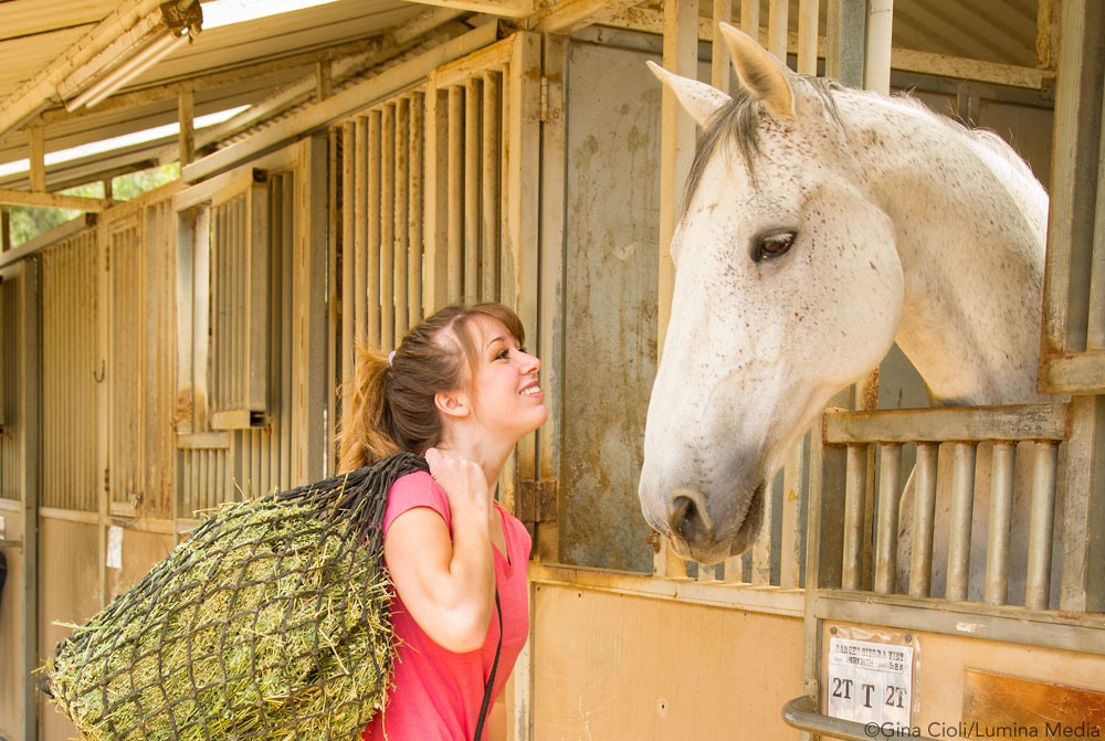 Woman with horse and hay net