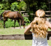 girl watching horse