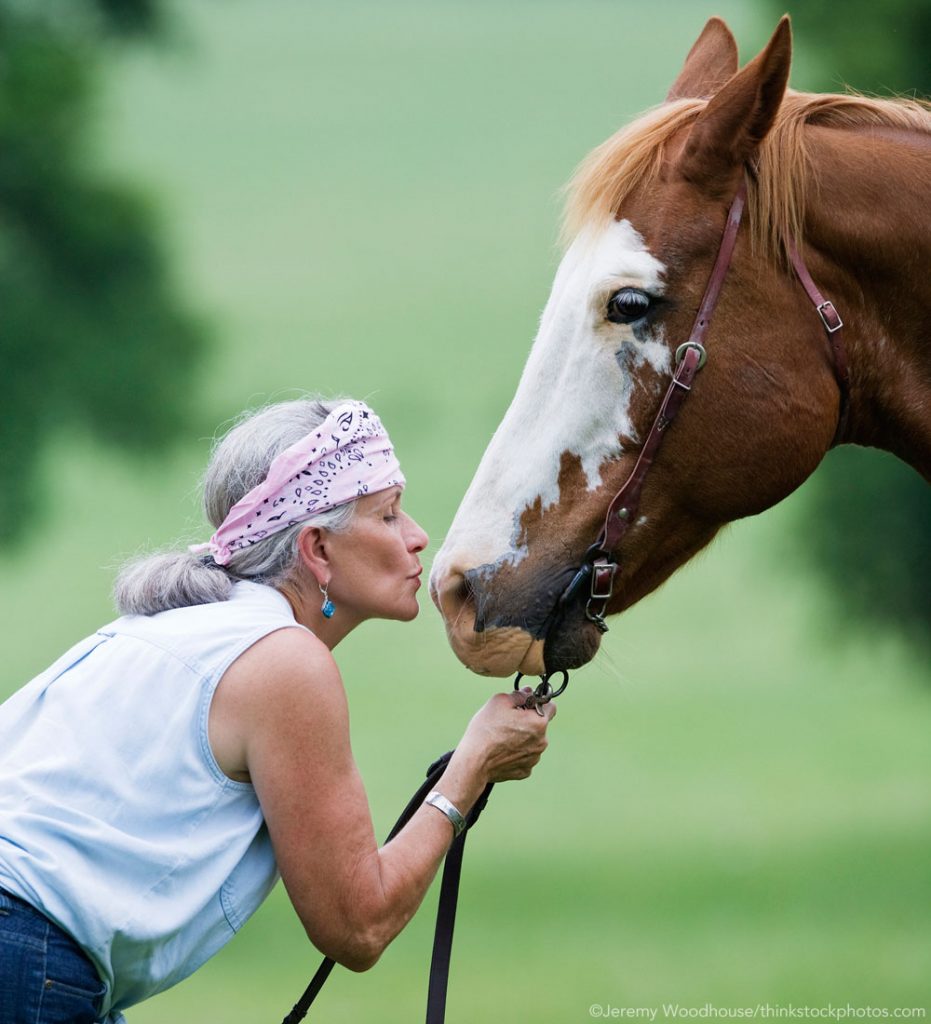 Older Woman kissing a Paint horse - Riding into the Golden Years