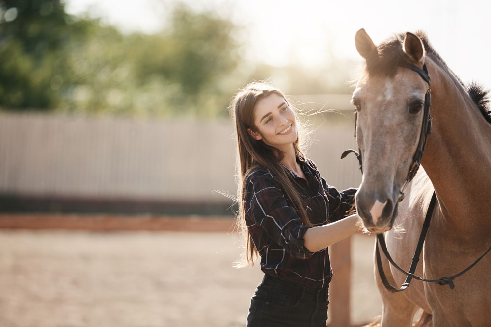 Woman with a buckskin horse