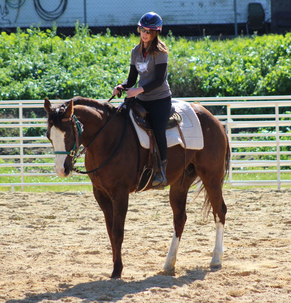 Trainer riding a rescue horse