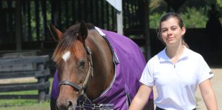 young equestrian with horse in a blanket