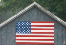 Horse barn with American flag
