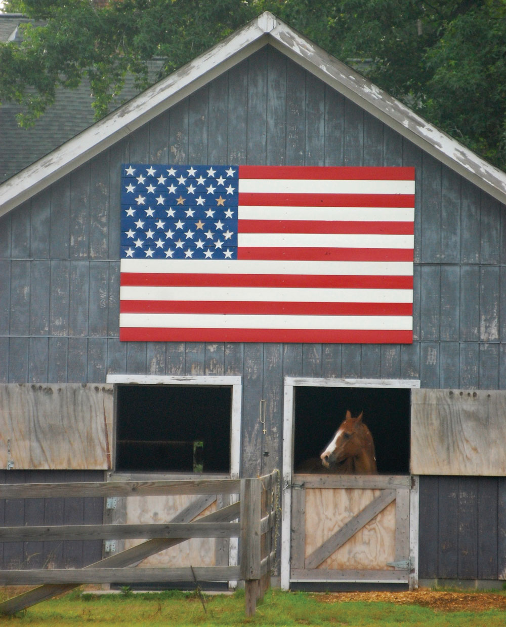 Horse barn with American flag