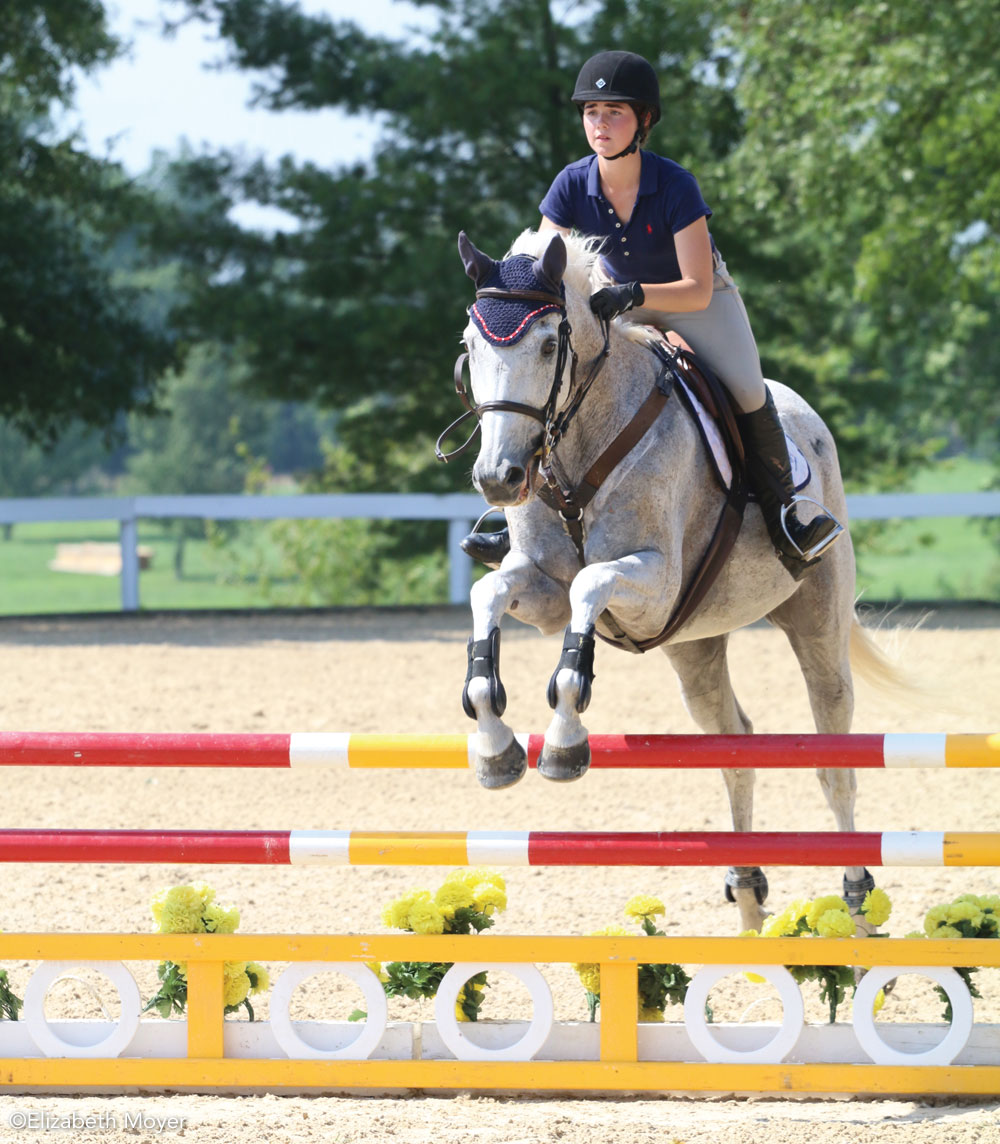 Young rider jumping