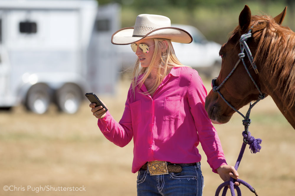 Woman with horse and phone