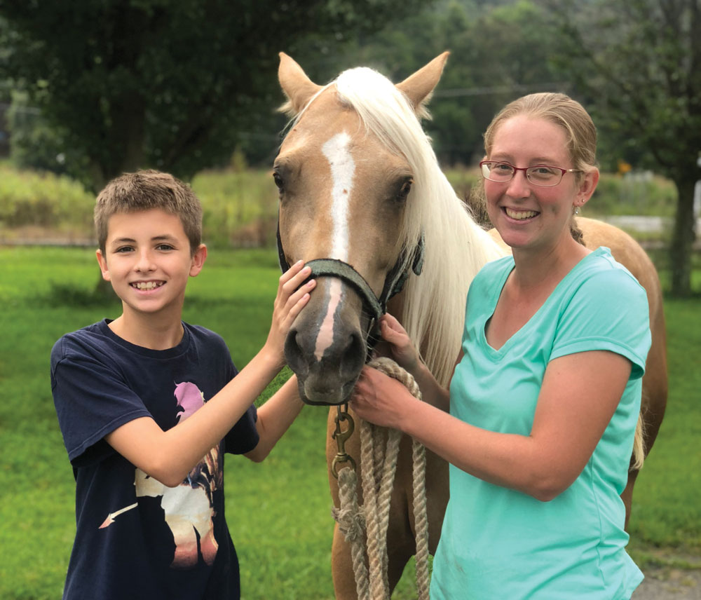 Halcyon’s son, Jackson Findley, with adopted horse Sansa and their trainer, Brenda Hanson.