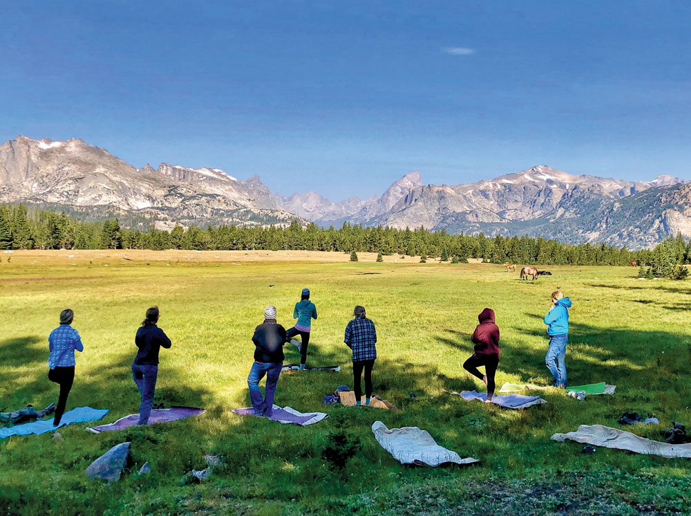 Equestrians participating in an outdoor yoga class at Diamond 4 Ranch