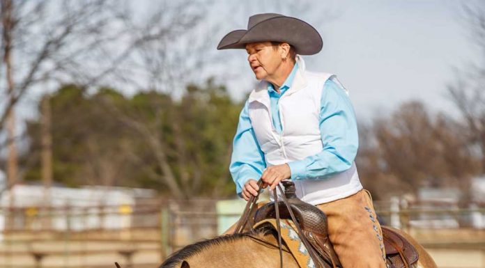 Brenda Hilgencamp riding a buckskin horse