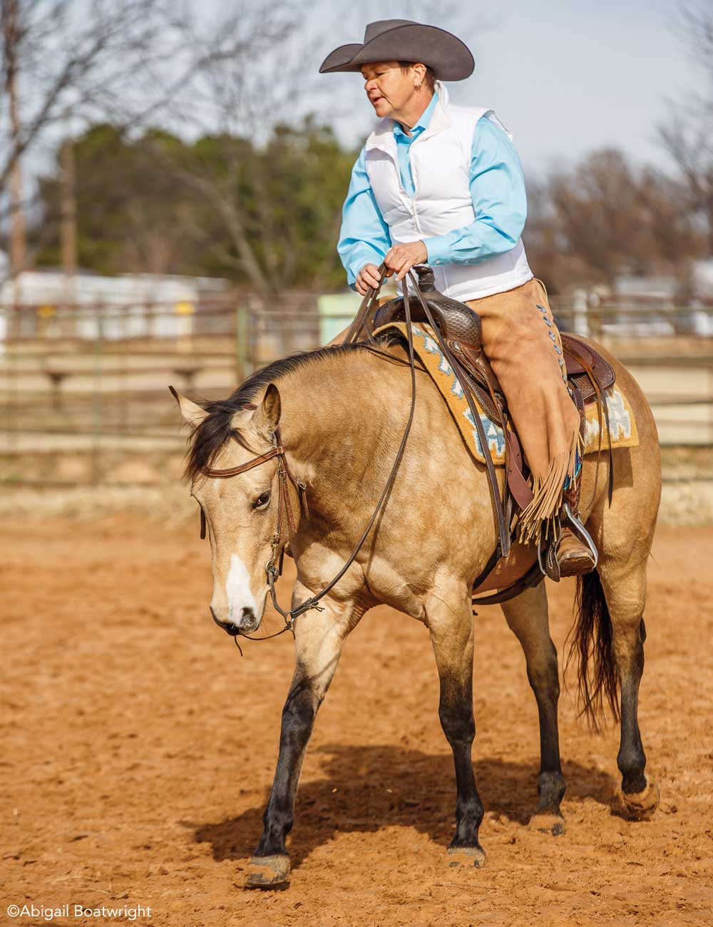 Brenda Hilgencamp riding a buckskin horse