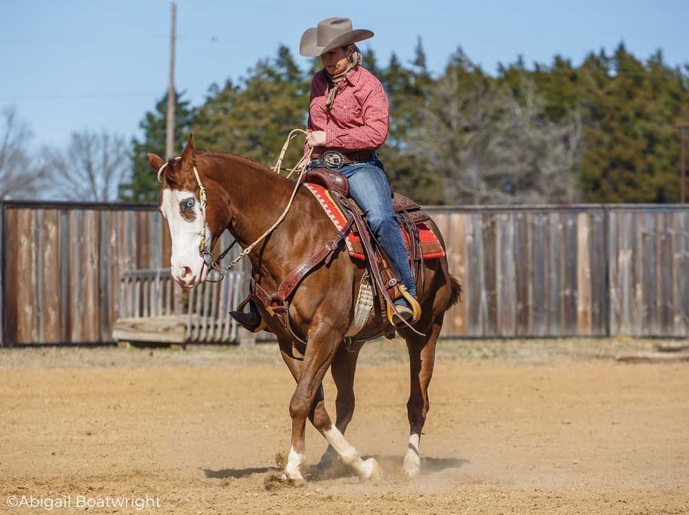 Trainer Heather Young riding a Paint Horse in a spin