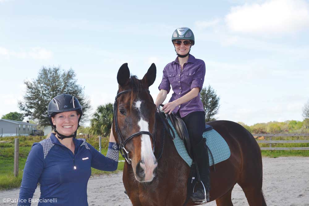 Two riders sharing a horse