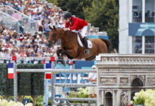 Karl Cook and Caracole de la Roque go clear during the Team Show Jumping Final at the 2024 Paris Olympics for the USA