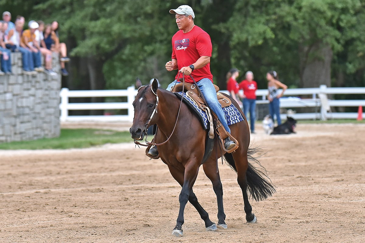 Retired Chief Navy Diver Michael Suzuki competing on a bay horse.