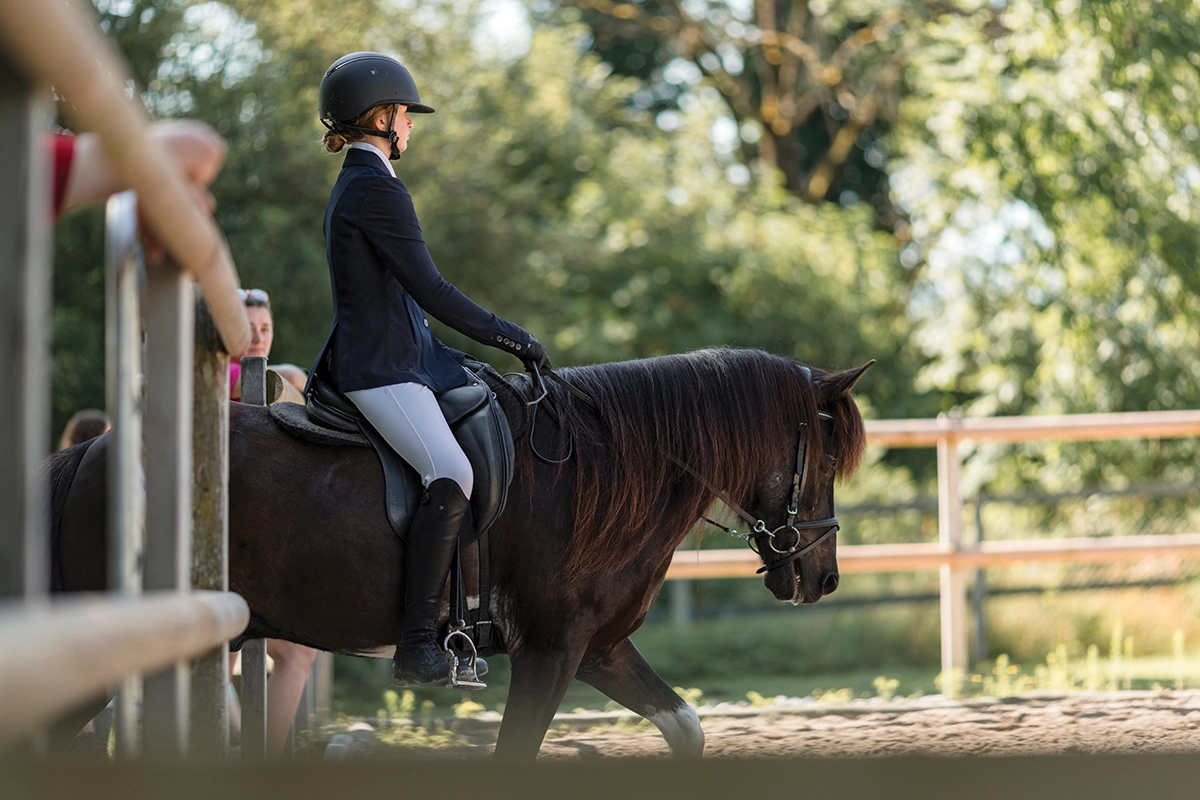 A young rider showing in dressage.