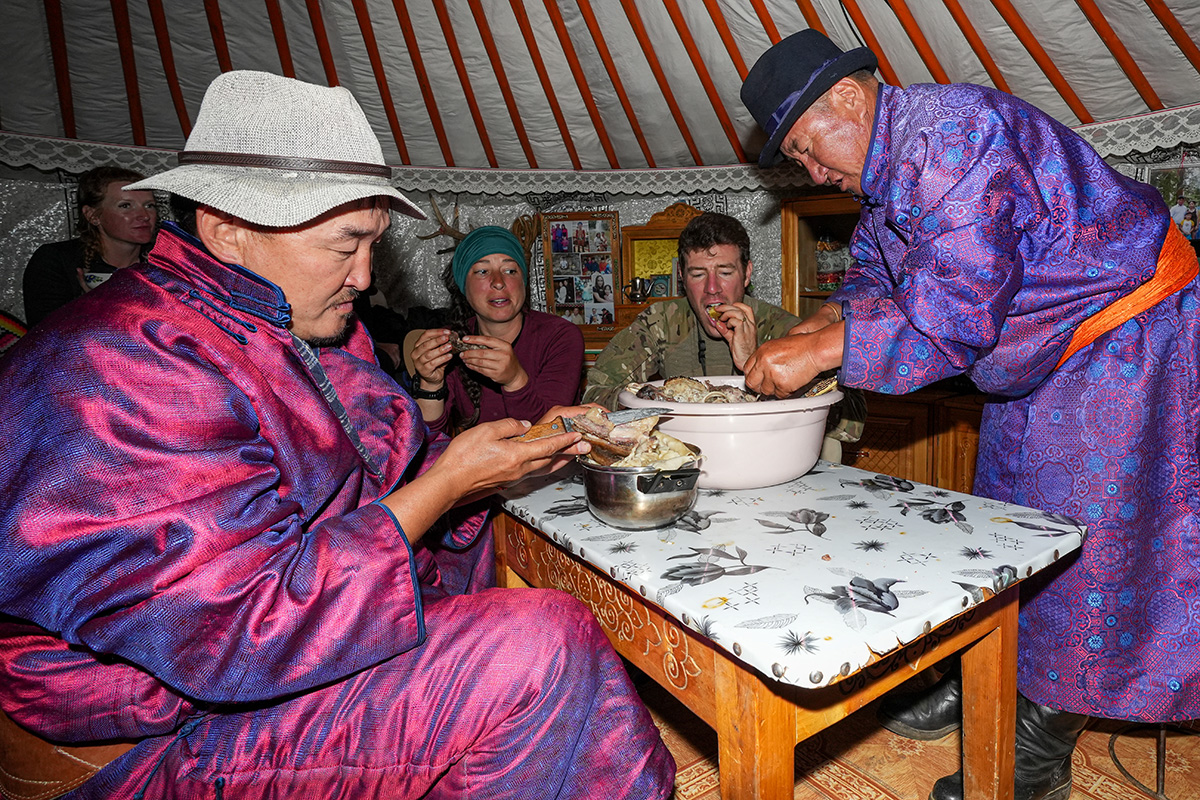 Riders enjoy dinner with a Mongolian family in a traditional ger.