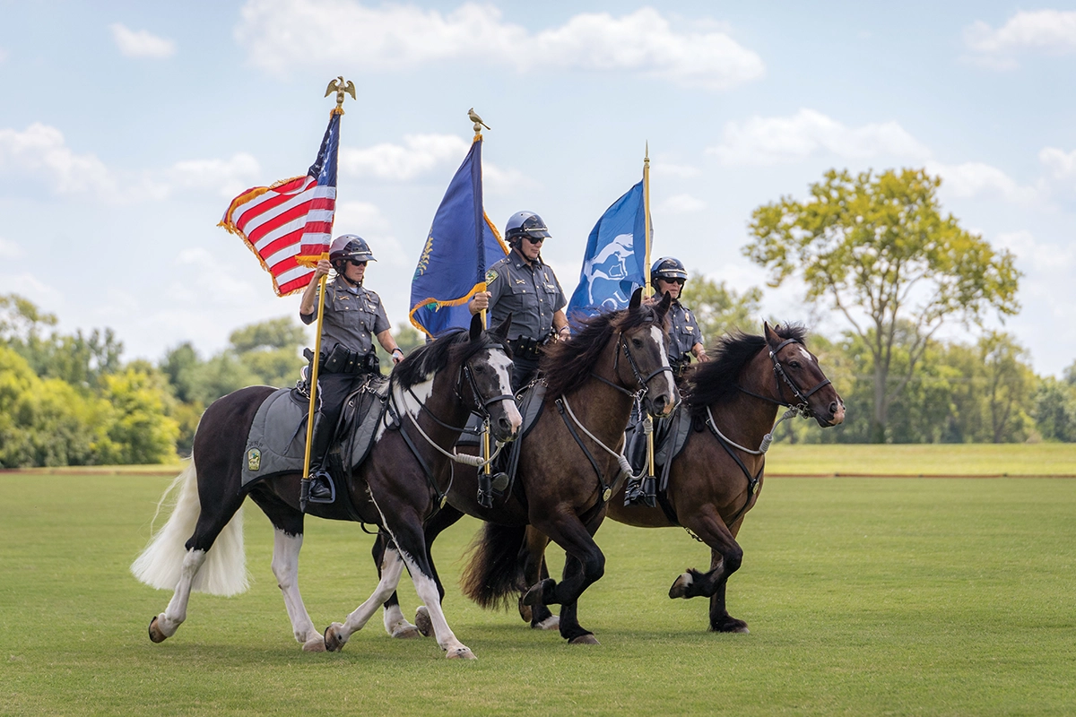 The presentation of the flags on horseback.