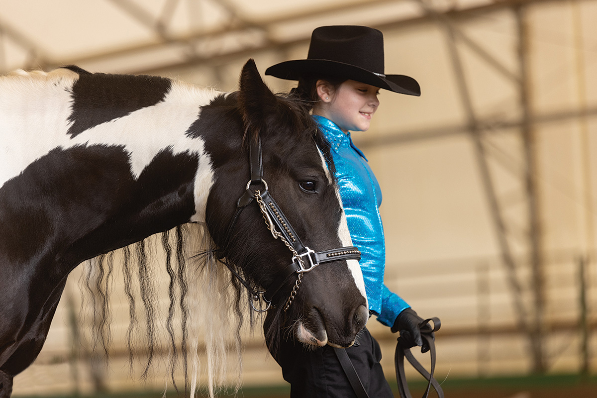 Ravenna Rider Evie competing in showmanship with Gypsy Vanner horse