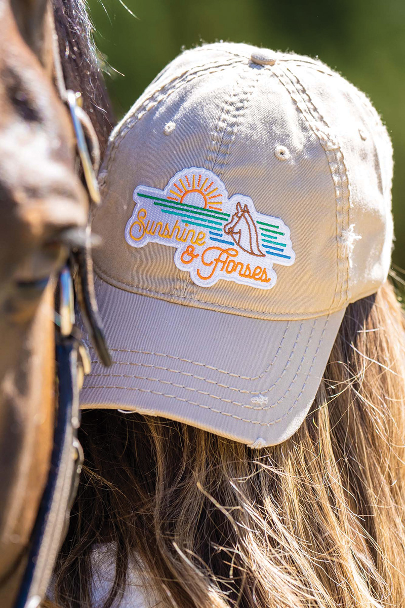 A ball cap that says "Sunshine & Horses"