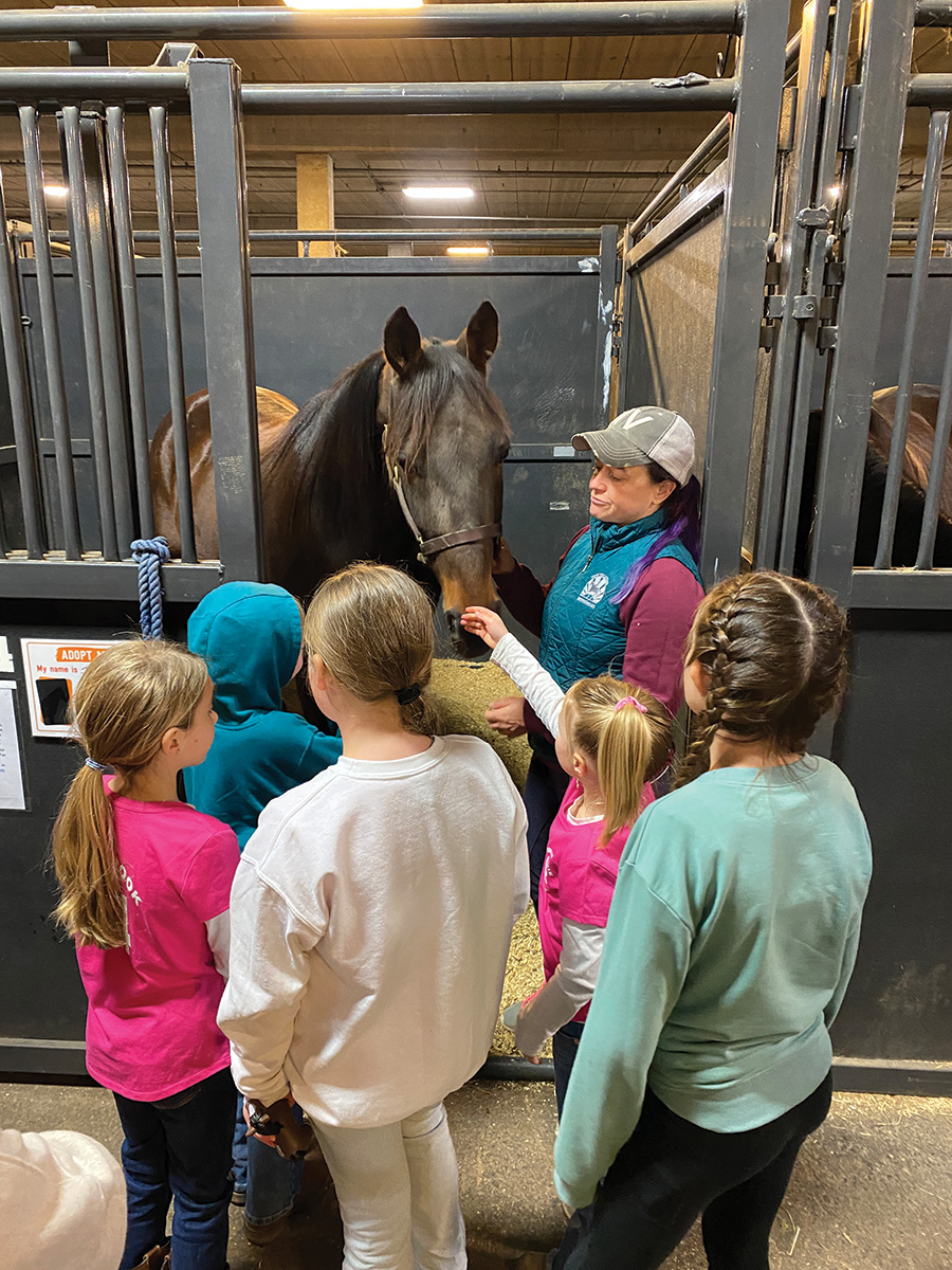 Young kids meet a horse at the event.
