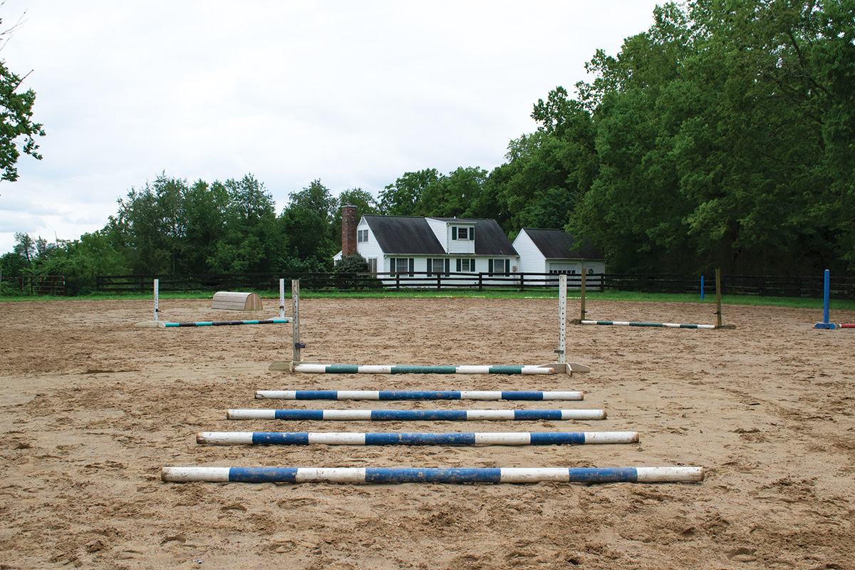 A row of canter poles for one of the horse exercises detailed in this article