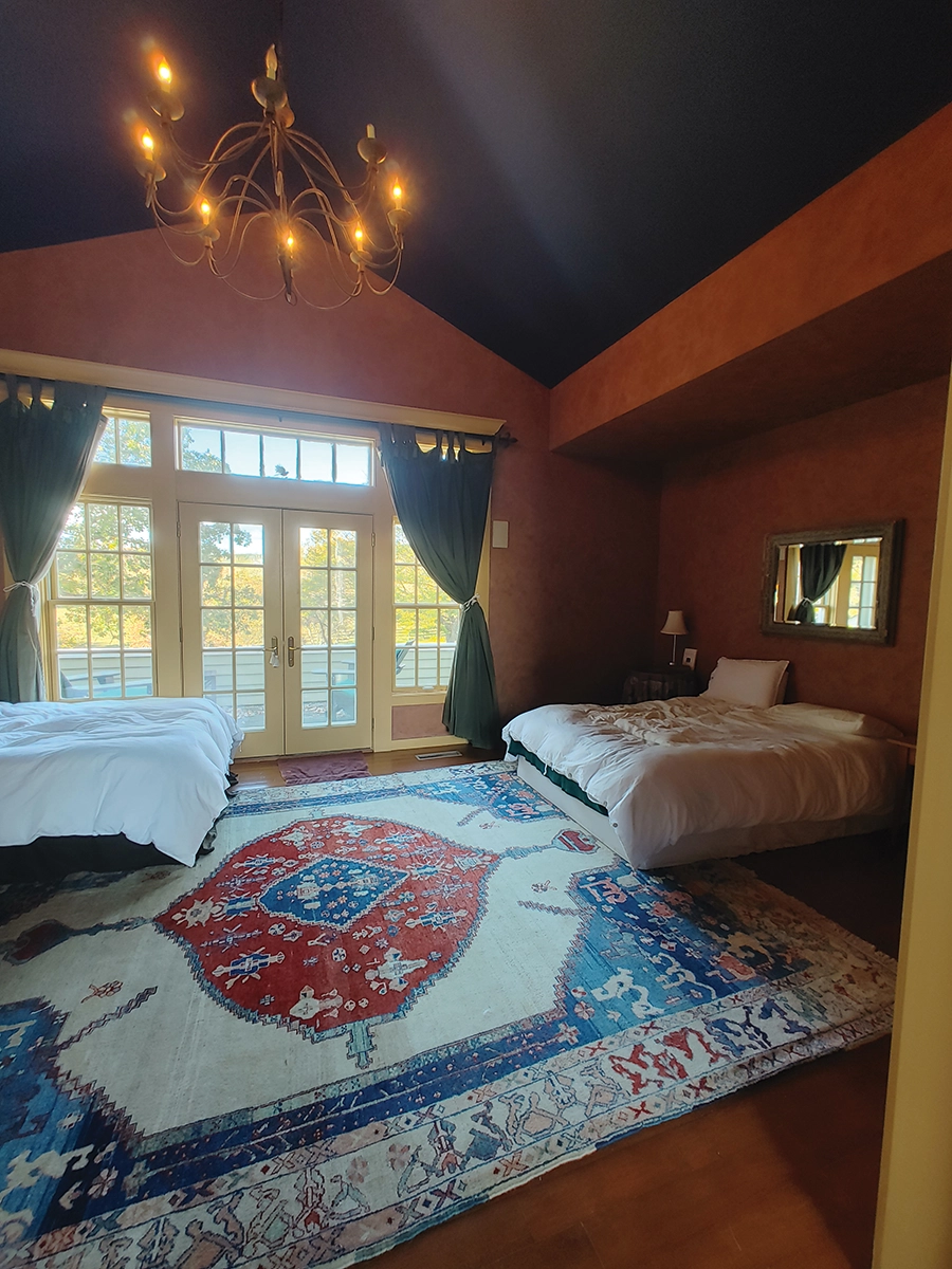 Two beds and a balcony view overlook the horse pastures at Windrock Farm.