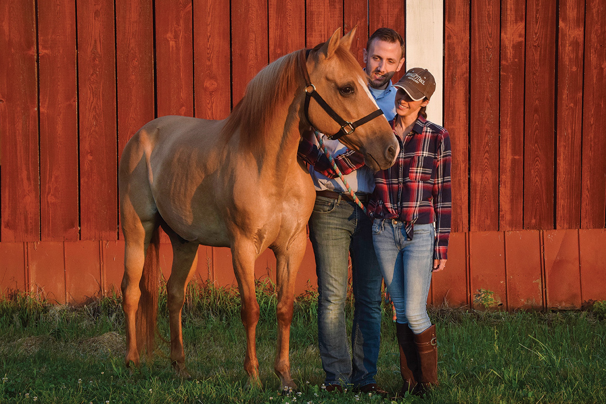 Butternut, an older Quarter Horse with special medical needs, poses with his family at his new home