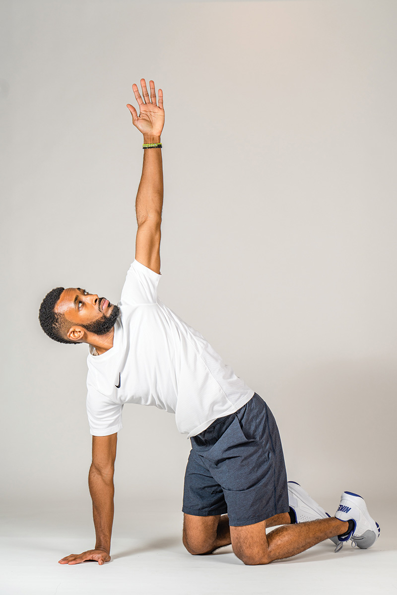 The author demonstrates the mid-back rotation, which helps prevent rider back pain.