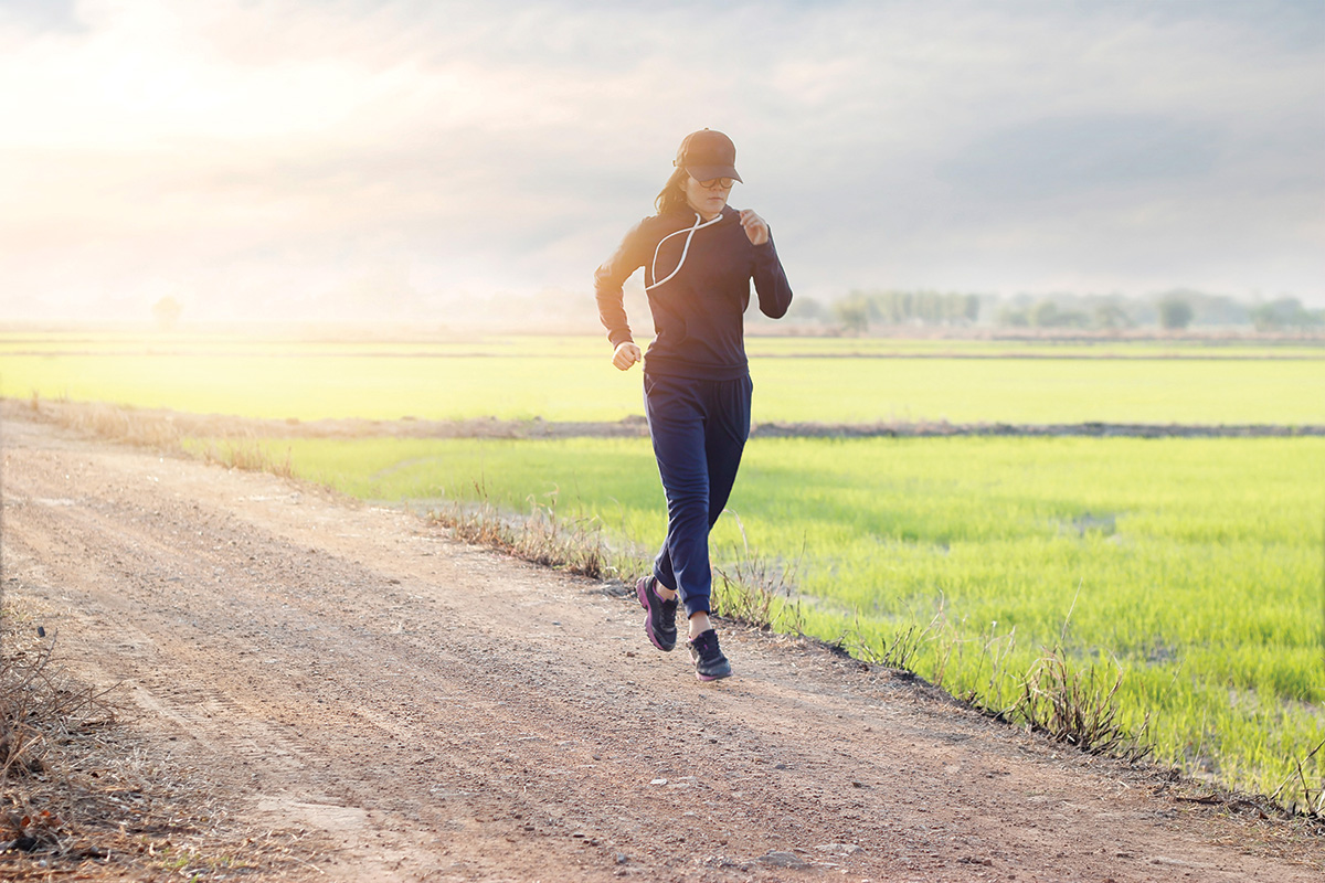 A girl running on a dirt road